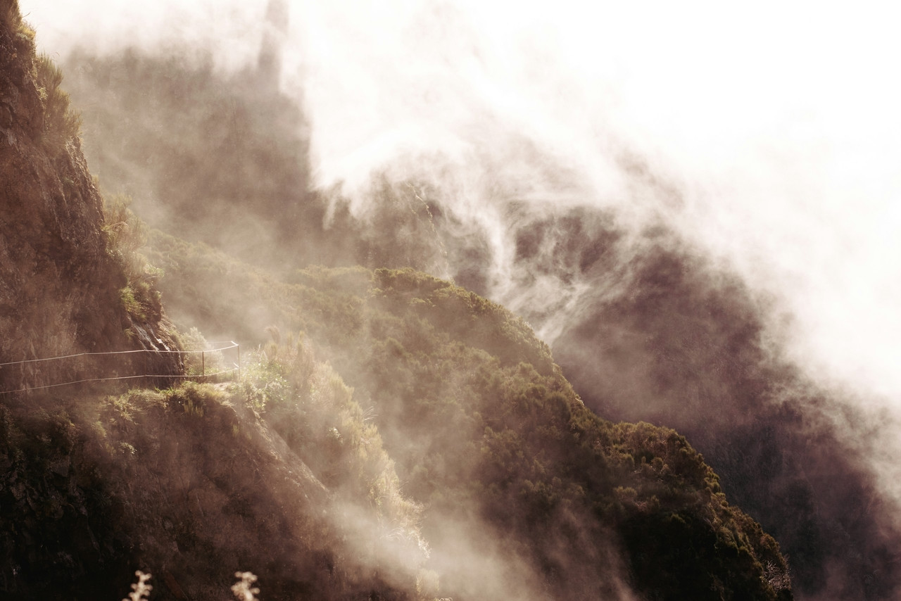a foggy mountain with a road going through it, Ultra
