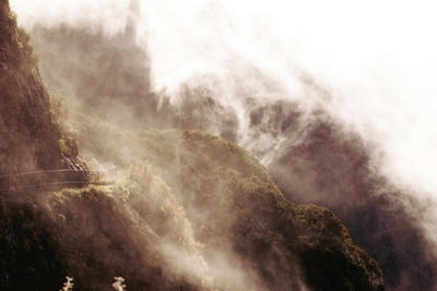 a foggy mountain with a road going through it, Ultra