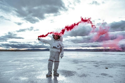 a man in a white space suit holding a red substance, Ultra