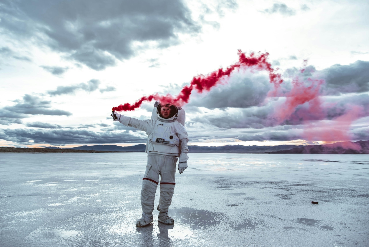 a man in a white space suit holding a red substance, Standard