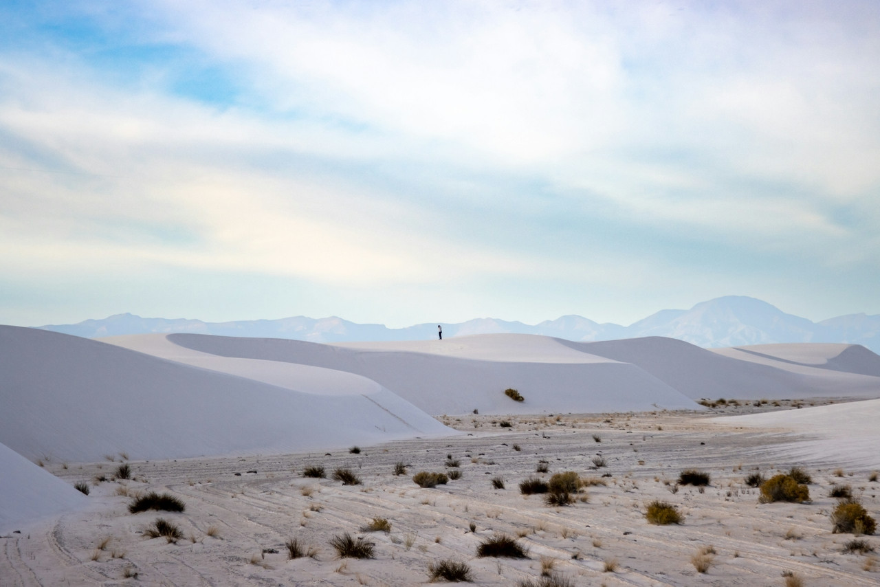 a person standing on top of a sandy hill, Standard