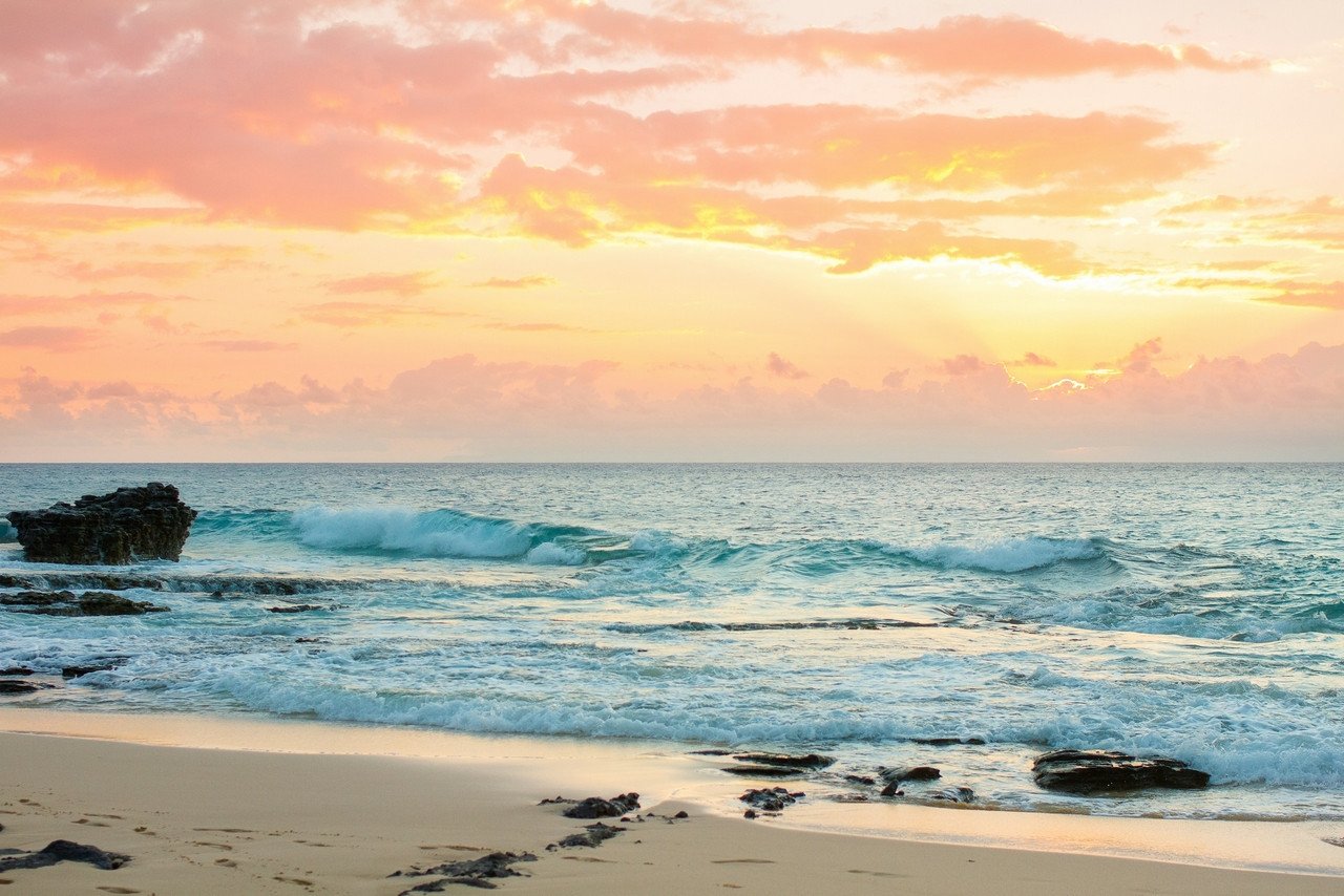 A sandy beach with waves coming in to shore, Ultra