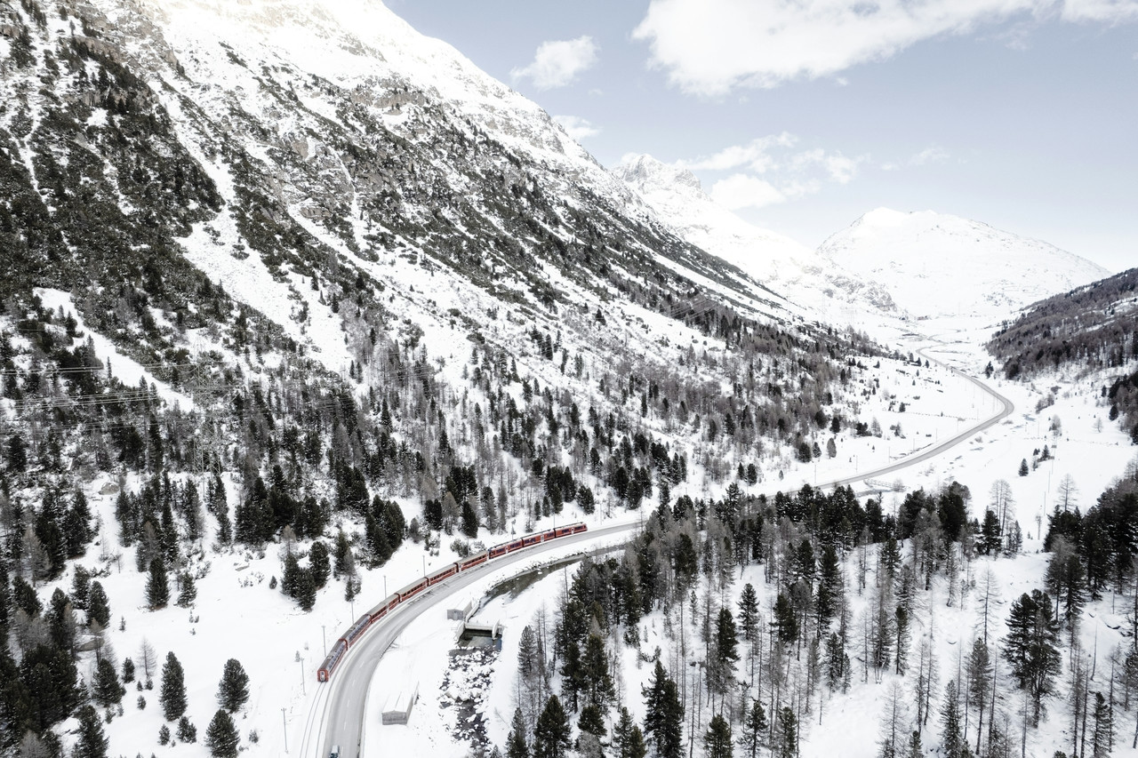 a train traveling through a snow covered mountain, Ultra