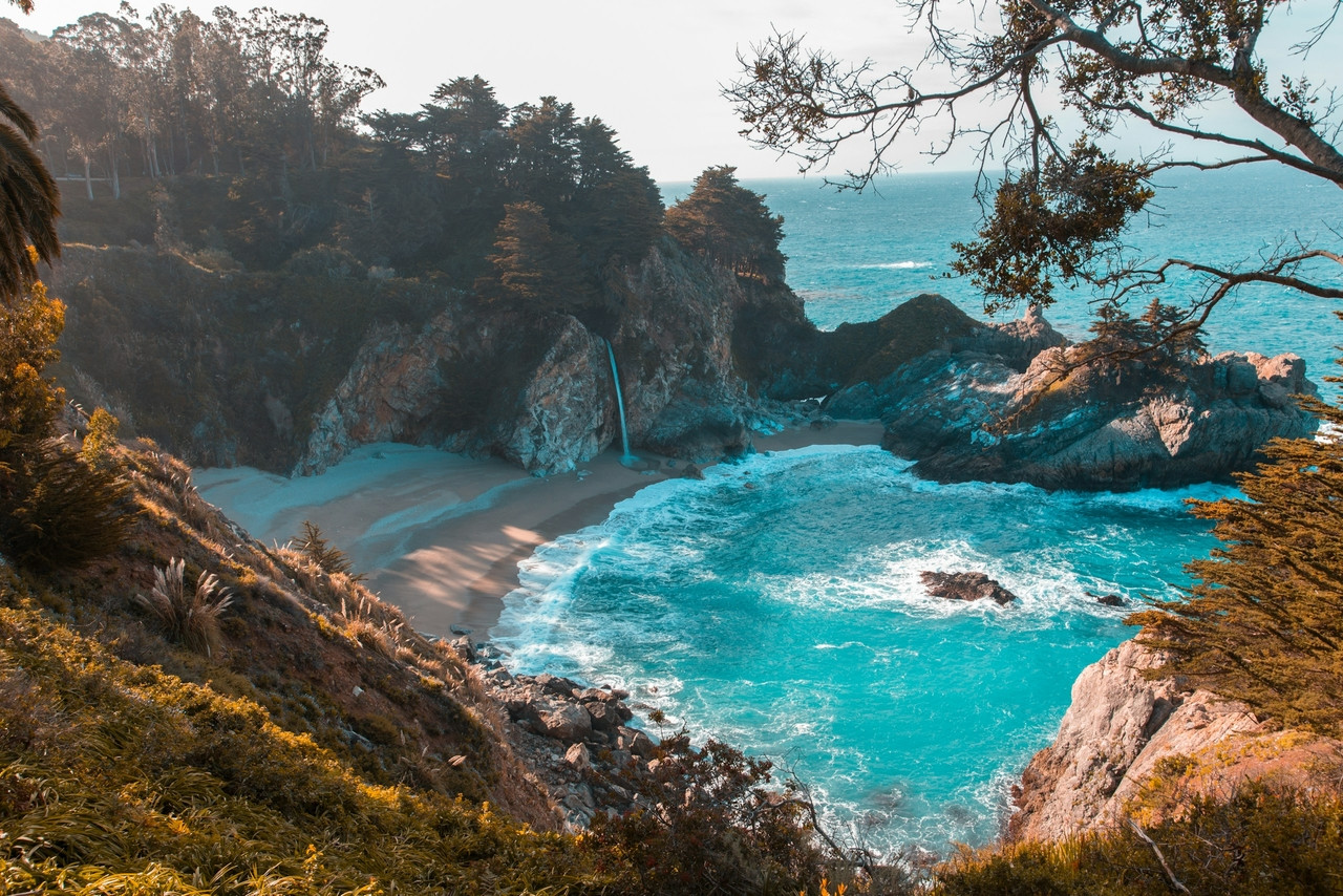 body of water near trees and mountain cliff during daytime, Standard