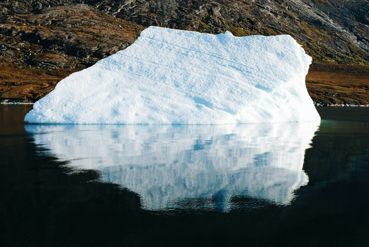 iceberg on water near mountain during daytime, Standard