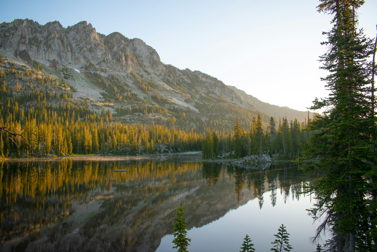Mountains and trees are reflected in a calm lake, Standard
