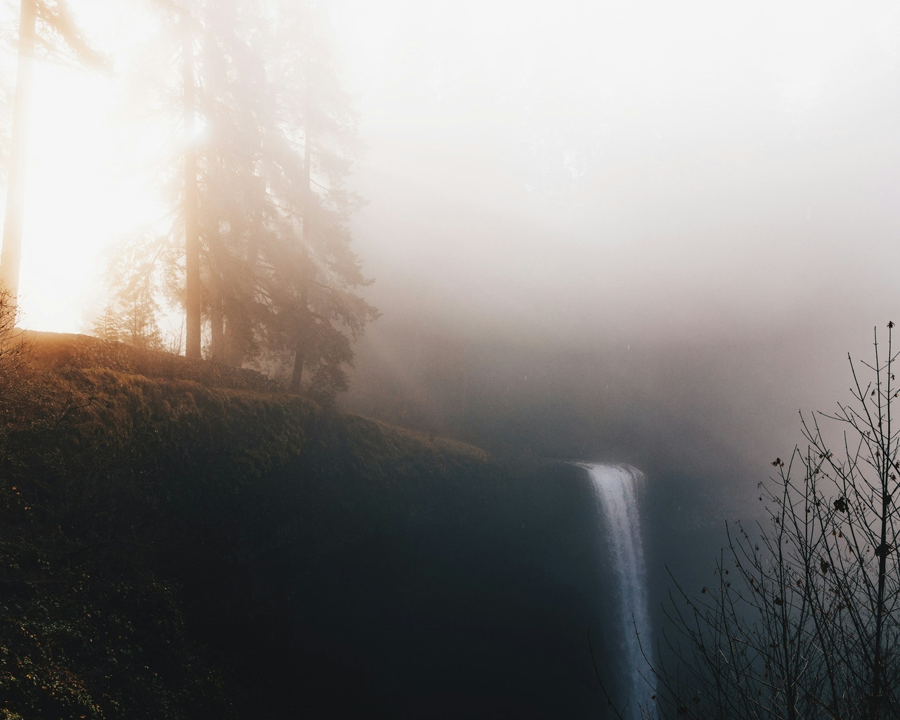 Waterfall cascades through the misty, sunny forest, Ultra